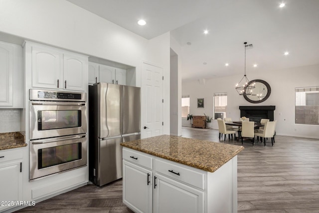 723 E Gemini Pl, Chandler, AZ 85249 - kitchen with stainless steel appliances, dark wood finished floors, a chandelier, open floor plan, and dark stone counters