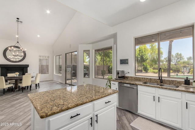 723 E Gemini Pl, Chandler, AZ 85249 - kitchen featuring stainless steel dishwasher, a chandelier, dark stone countertops, a center island, and wood finished floors