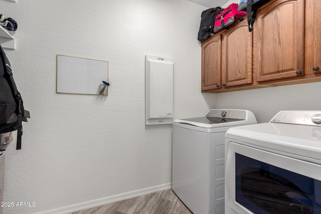 723 E Gemini Pl, Chandler, AZ 85249 - laundry room with washing machine and dryer, cabinet space, and light wood-style floors