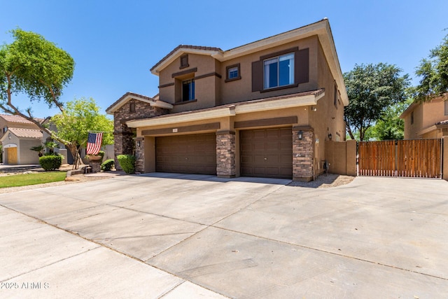 723 E Gemini Pl, Chandler, AZ 85249 - view of front of property featuring stone siding, an attached garage, concrete driveway, a gate, and stucco siding