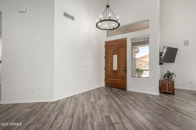 723 E Gemini Pl, Chandler, AZ 85249 - foyer entrance featuring wood finished floors, a chandelier, and a high ceiling