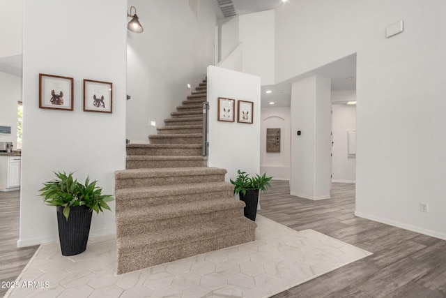 723 E Gemini Pl, Chandler, AZ 85249 - staircase featuring wood finished floors and a high ceiling