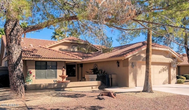 mediterranean / spanish-style house featuring a garage