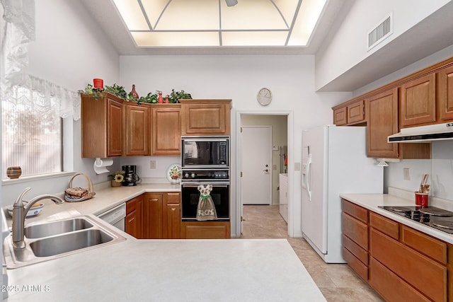 kitchen featuring sink, black appliances, kitchen peninsula, and light tile patterned flooring