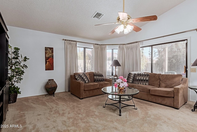 living room with light carpet, ceiling fan, lofted ceiling, and a textured ceiling