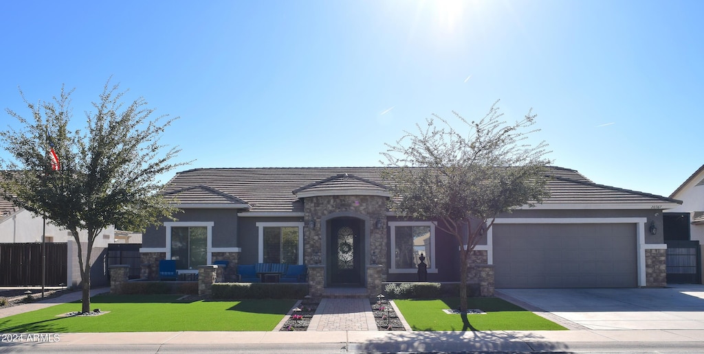 view of front of property featuring a garage and a front yard