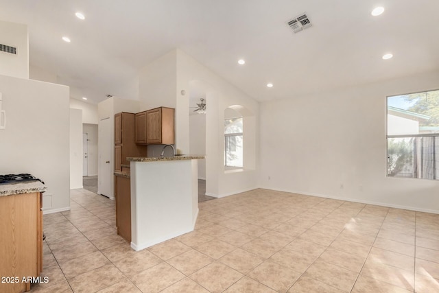 kitchen featuring ceiling fan, light tile patterned floors, and a healthy amount of sunlight