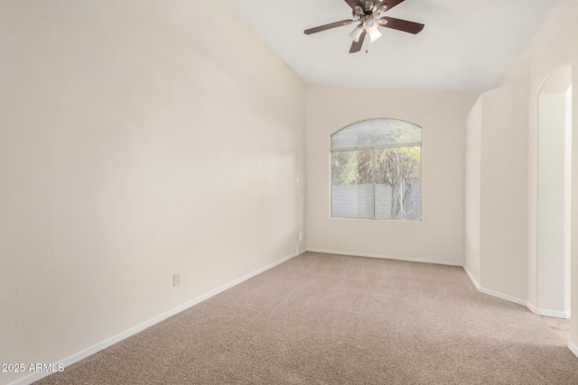 carpeted spare room featuring ceiling fan