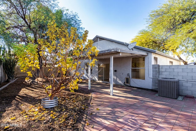 back of house with central AC unit and a patio