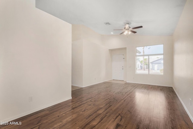 empty room with ceiling fan, dark wood-type flooring, and vaulted ceiling