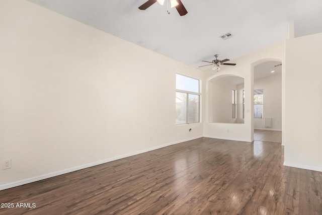 spare room with ceiling fan and dark hardwood / wood-style flooring