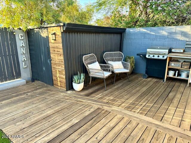 wooden terrace with a grill