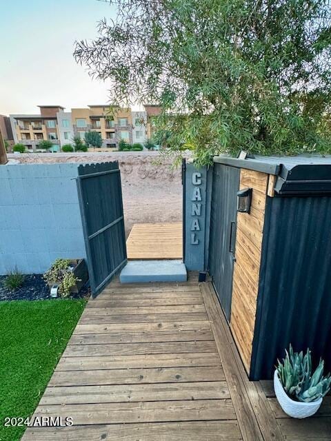 view of gate featuring a wooden deck