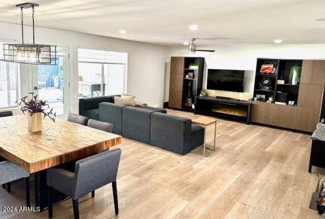 living room featuring light hardwood / wood-style floors and a notable chandelier