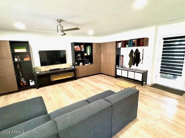 living room featuring light wood-type flooring and ceiling fan