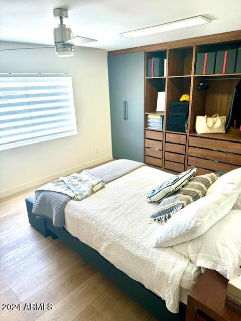 bedroom with ceiling fan and hardwood / wood-style flooring