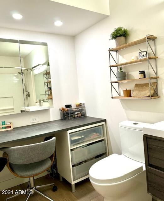 bathroom with a shower, vanity, and toilet