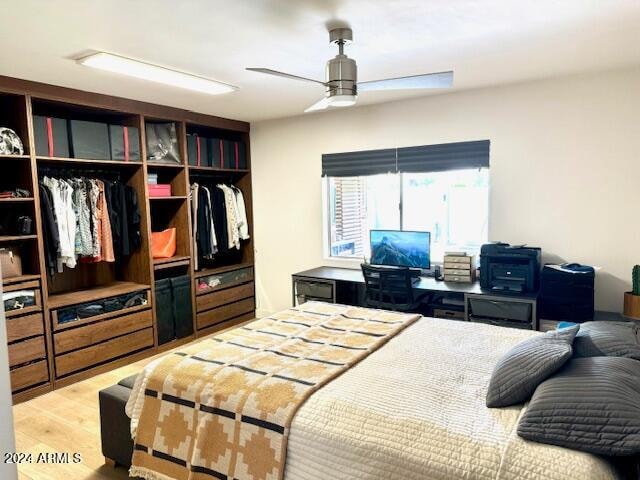 bedroom with ceiling fan, a closet, and light wood-type flooring