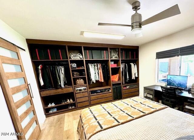 bedroom featuring ceiling fan, a closet, and hardwood / wood-style flooring