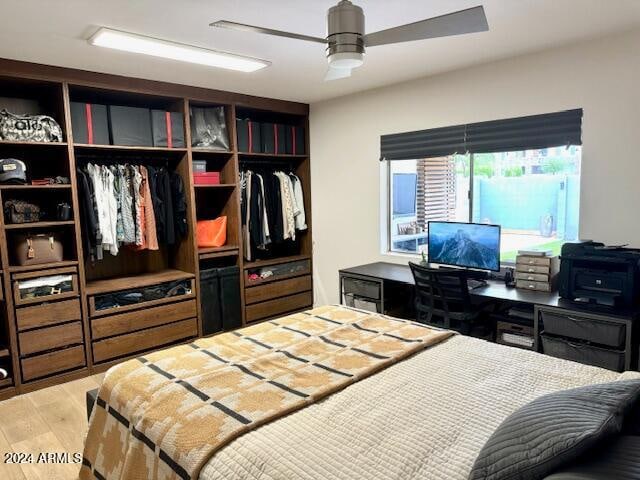 bedroom with ceiling fan, light hardwood / wood-style flooring, and a closet