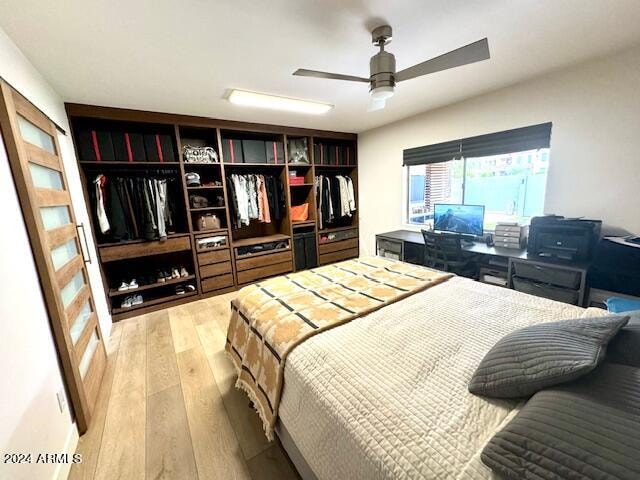 bedroom featuring light hardwood / wood-style floors, ceiling fan, and a closet