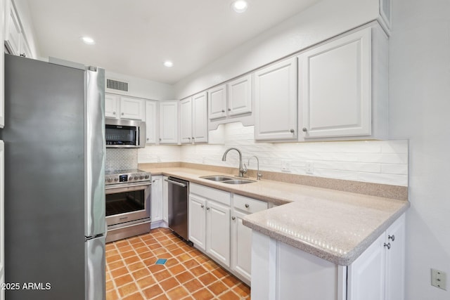 4800 N 68th St Unit 357, Scottsdale, AZ 85251 - kitchen featuring stainless steel appliances, a sink, white cabinets, light countertops, and tasteful backsplash