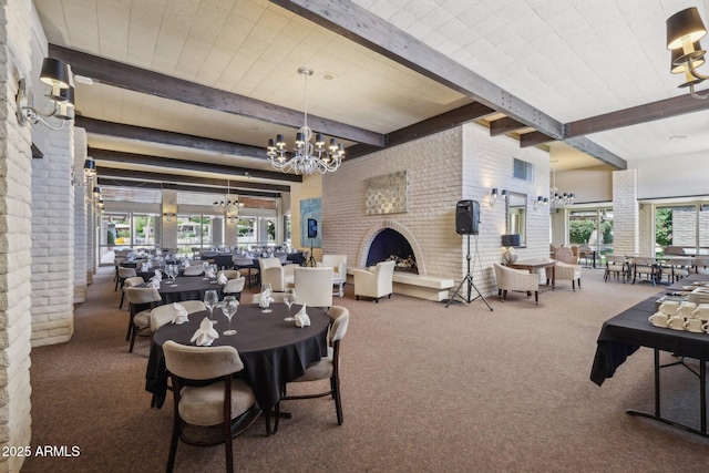 4800 N 68th St Unit 357, Scottsdale, AZ 85251 - dining space with beamed ceiling, a chandelier, carpet flooring, a fireplace, and brick wall