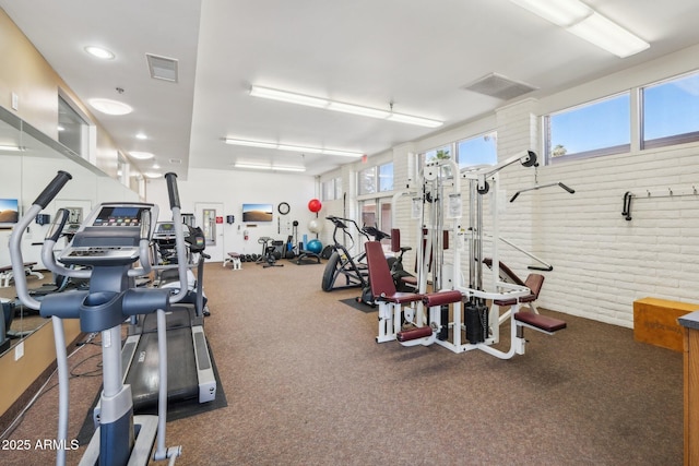 4800 N 68th St Unit 357, Scottsdale, AZ 85251 - exercise room featuring carpet flooring and brick wall
