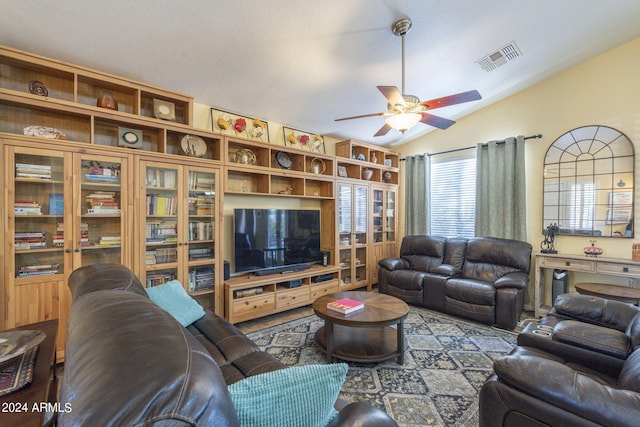 living room with ceiling fan and vaulted ceiling