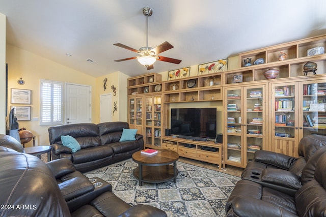 living room featuring ceiling fan and lofted ceiling