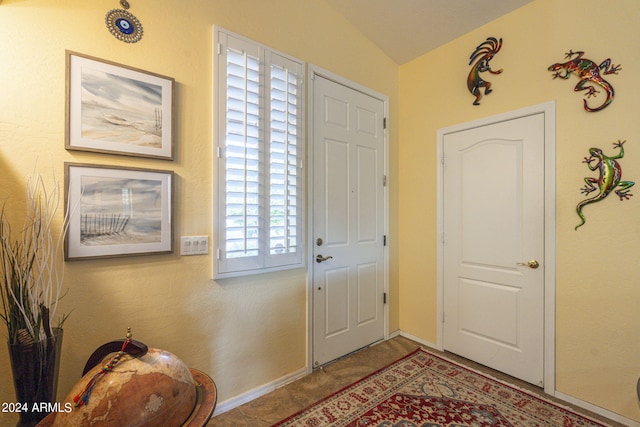 entryway featuring lofted ceiling and a healthy amount of sunlight