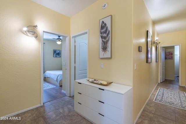 hallway with dark tile patterned floors