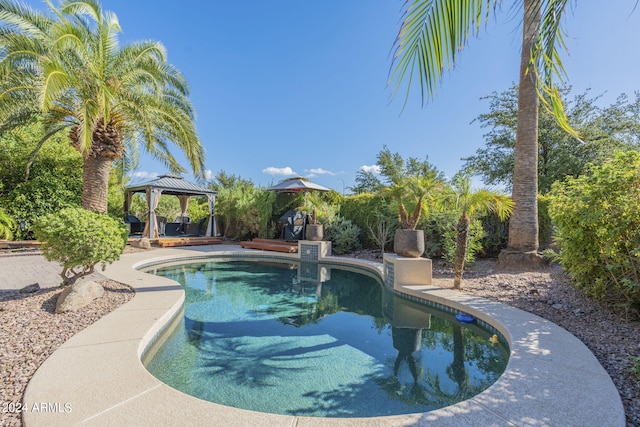 view of swimming pool featuring a gazebo and a patio area