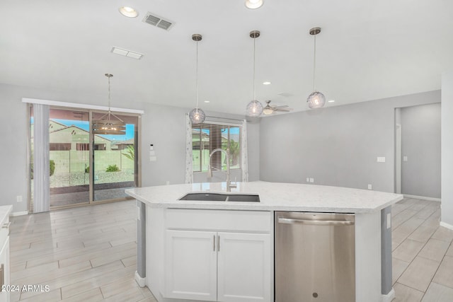 kitchen featuring ceiling fan, pendant lighting, sink, stainless steel dishwasher, and white cabinetry