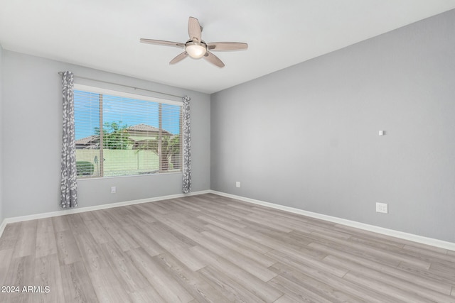 empty room with light hardwood / wood-style flooring and ceiling fan