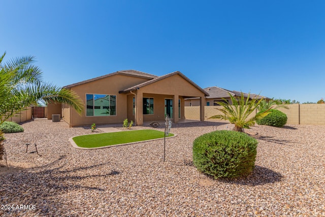 rear view of property featuring central AC unit and a patio area