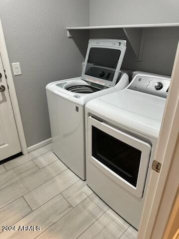 clothes washing area with separate washer and dryer