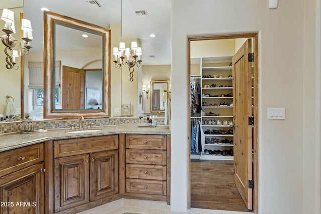 bathroom with vanity, wood-type flooring, and backsplash