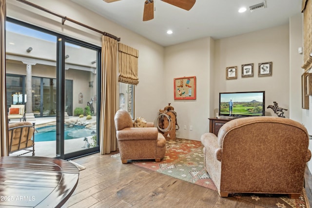 living room featuring hardwood / wood-style flooring and ceiling fan