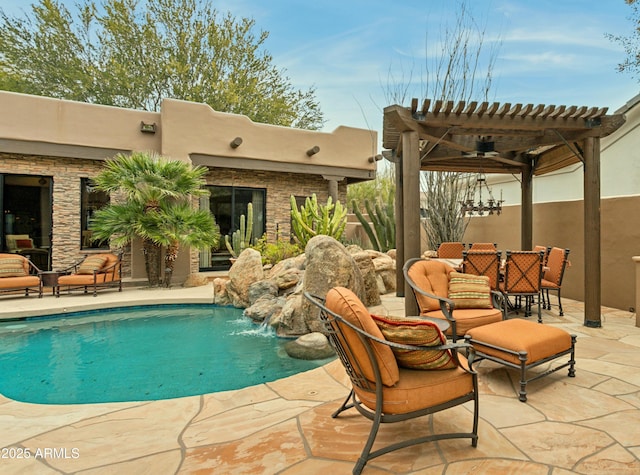 view of pool featuring pool water feature, a patio area, and a pergola