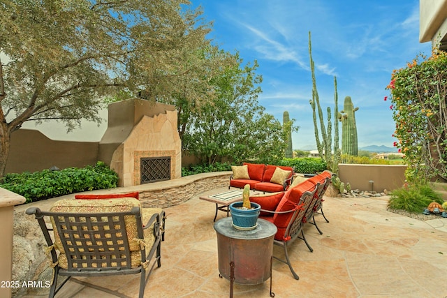 view of patio featuring an outdoor stone fireplace