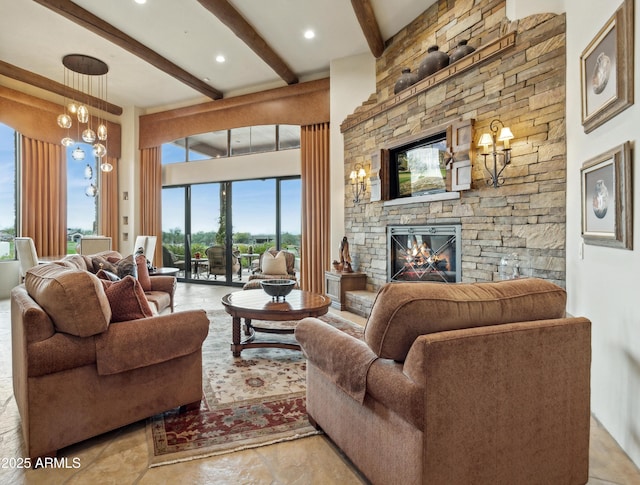 living room with an inviting chandelier, a stone fireplace, and beam ceiling