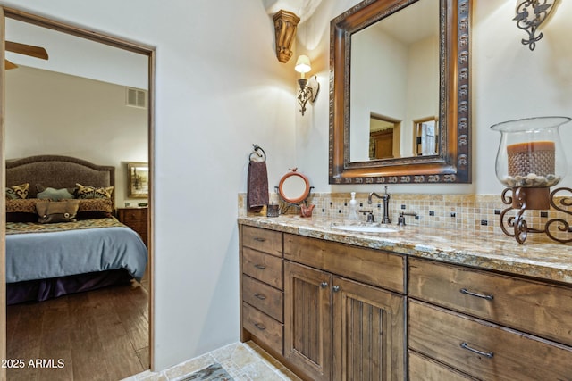 bathroom with vanity and decorative backsplash