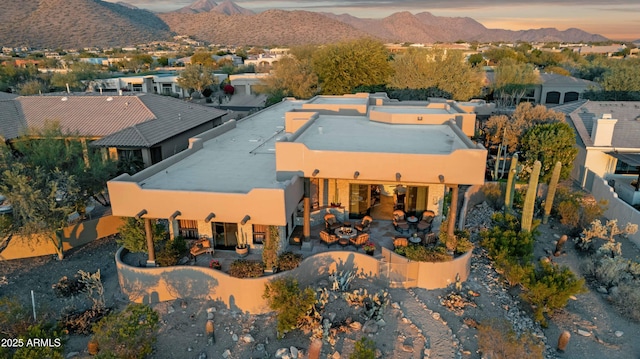 aerial view at dusk featuring a mountain view