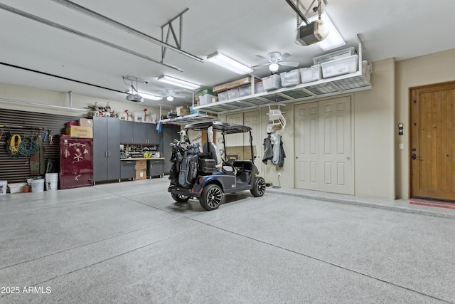 garage featuring a garage door opener and a workshop area