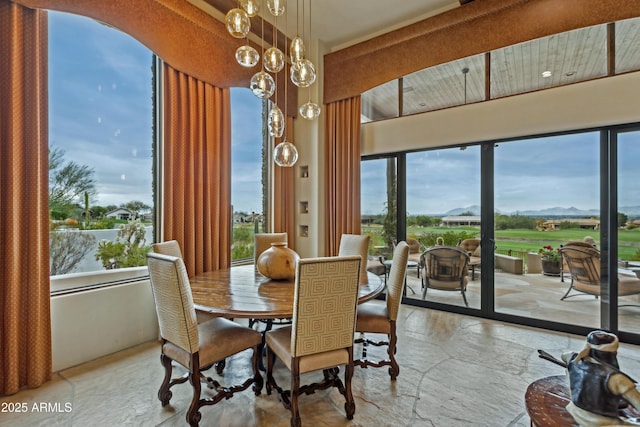 dining area with an inviting chandelier and plenty of natural light