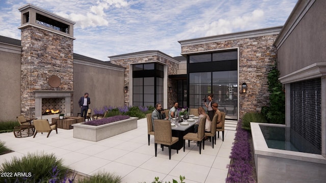 view of patio / terrace featuring an outdoor stone fireplace