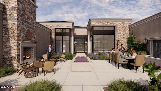 view of patio featuring an outdoor stone fireplace