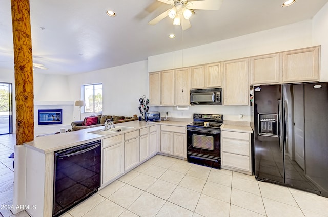 kitchen with kitchen peninsula, ceiling fan, light tile patterned flooring, black appliances, and sink