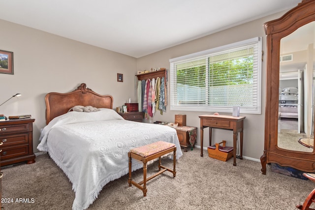 bedroom featuring baseboards, visible vents, and light colored carpet